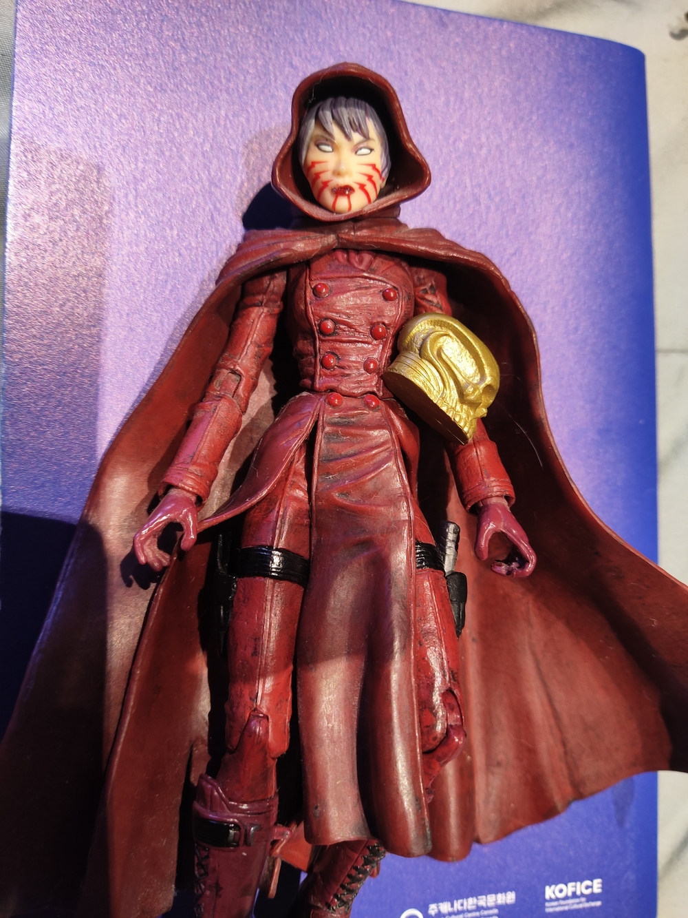 Red Hooded Female Action Figure with Gold Helmet Accessory